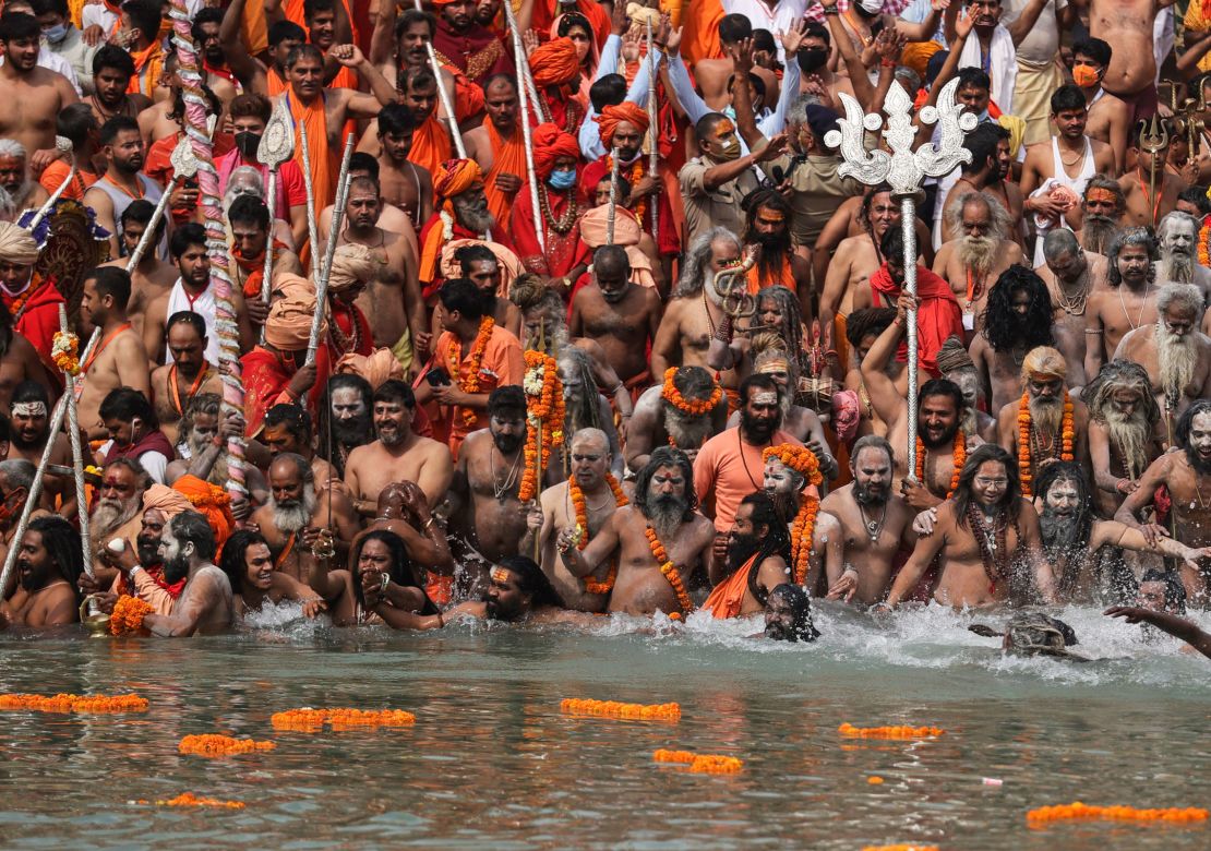 Naked Hindu holy men take dips in the Ganges River during Kumbh Mela, one of the most sacred pilgrimages in Hinduism, in Haridwar, northern state of Uttarakhand, India, on April 12, 2021. 