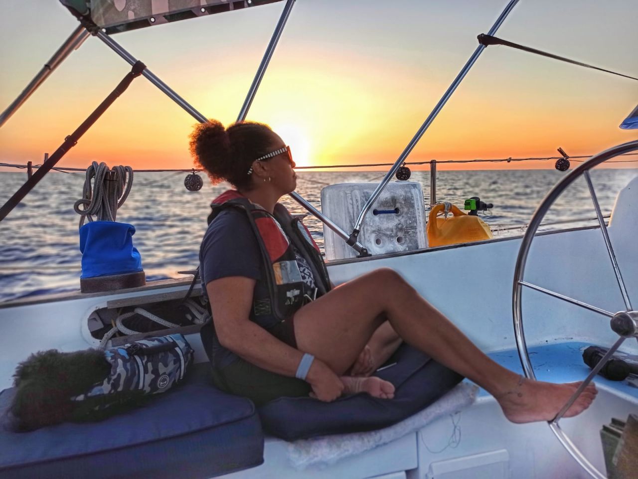 <strong>From RV to boat: </strong>Maggie Jay and Damien Williams bought a boat after an engine fire ended a years-long RV adventure. Here Jay helms with her foot to Bimini, Bahamas. The couple plans to sail to Puerto Rico to get married.