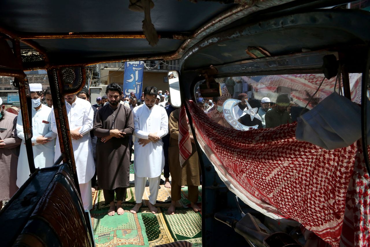 Muslims take part in Friday prayers outside a mosque in Peshawar, Pakistan, on April 23.