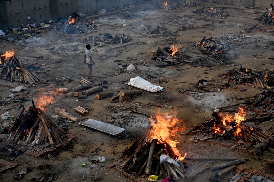A man stands amid burning pyres of Covid-19 victims at a crematorium in New Delhi, India, on April 26.