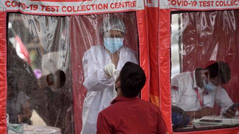 A healthcare worker collects swab samples at a Covid-19 testing center in Mumbai, India, on April 22.