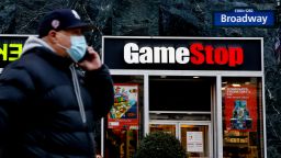 A man talks by his phone in front of GameStop at 6th Avenue on February 25, 2021 in New York. GameStop Corp. doubled its shares and and jumped another 19 percent today and the betting are that GameStop shares would spike to $800 on Friday. (Photo by John Smith/VIEWpress via Getty Images)