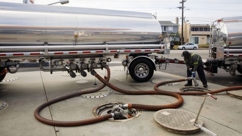 A worker disconnects hoses after delivering gasoline to a  station in Redondo Beach, California. A shortage of tanker truck drivers could cause some stations to run out of gas this summer, according to industry experts.