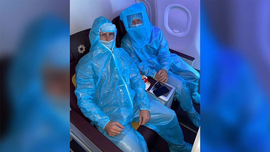 A photo of Warner and Williamson on a flight wearing full PPE. 