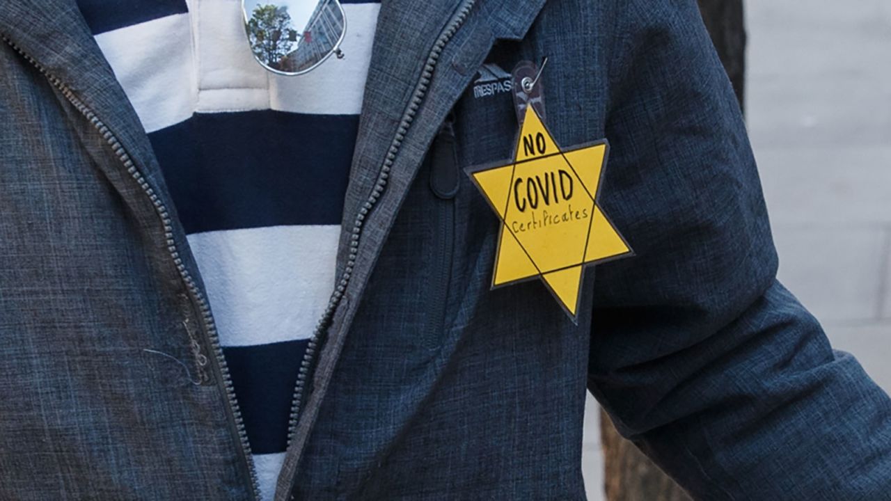 A protester wears a yellow Star of David with "No Covid certificates" printed on it while marching in London for the "Unite for Freedom" anti-lockdown and anti-vaccines protest on April 24.