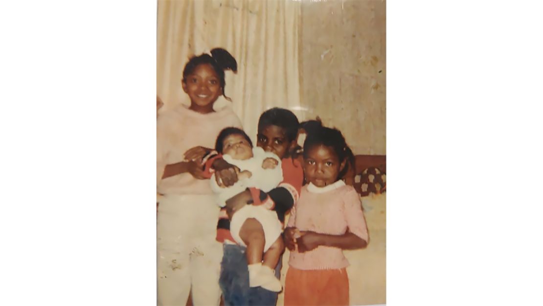 Linda Rowe Thomas (in white) with her siblings. Her sister (bottom right) died from burns sustained when a heater exploded.