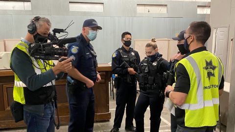Newly graduated officers and veterans of the force go through a live-action role play of a distress call to train for de-escalation techniques.
