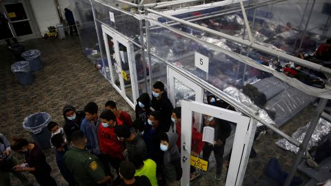 Young minors talk to an agent at the Donna Department of Homeland Security holding facility in the Rio Grande Valley, March 30, 2021.