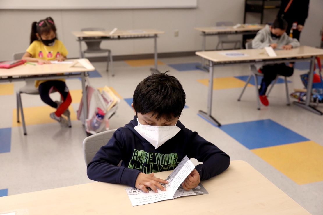 A first-grader works on an English exercise on the first day of class in Los Angeles on April 13, 2021. 