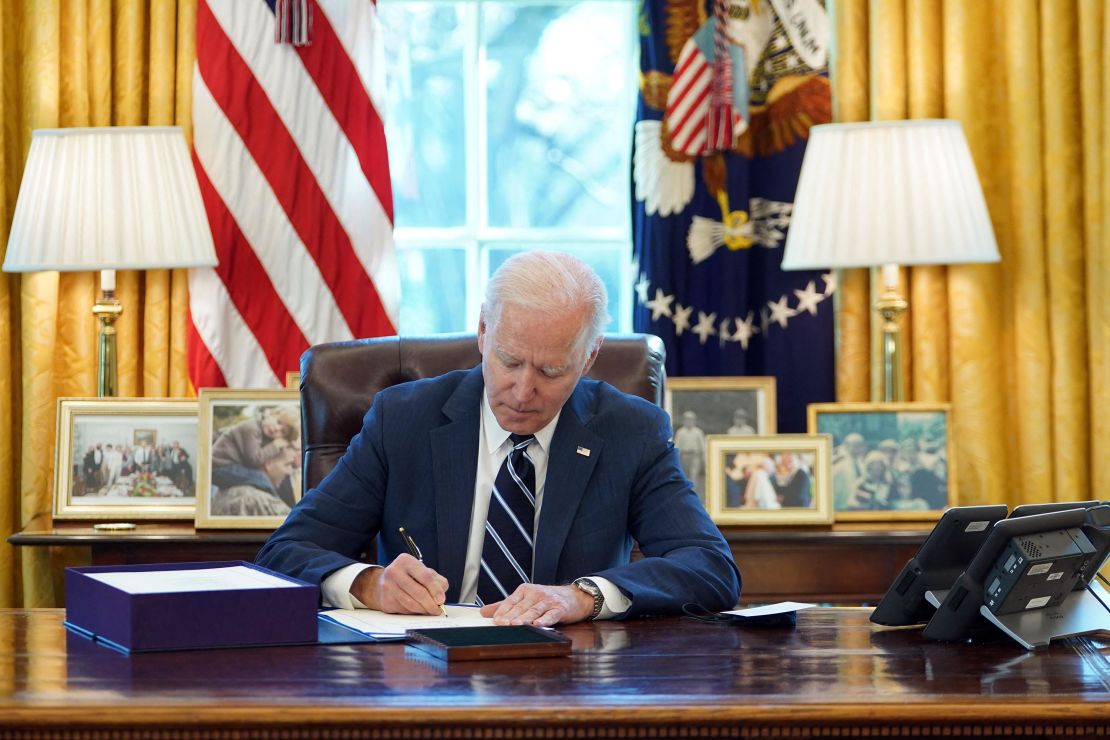Biden signs the American Rescue Plan on March 11, 2021.