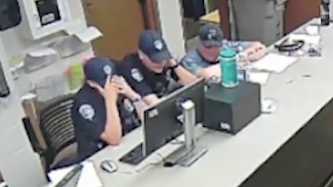 Loveland, Colorado, police officers watch body camera footage of Karen Garner's arrest.