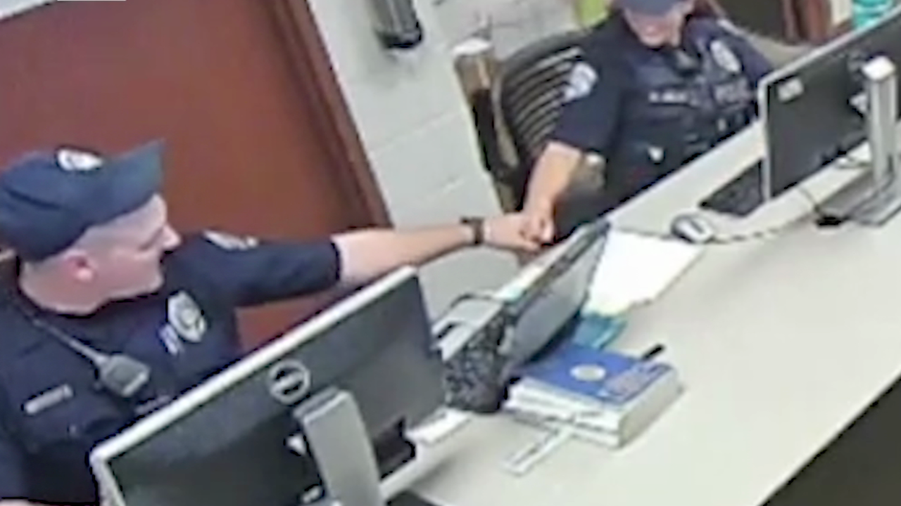 Officers are seen on video fist-bumping while having discussions about the arrest of Karen Garner on June 26, 2020.
