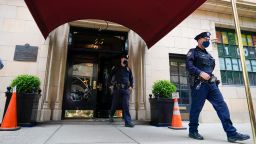 New York City Police officers walk out of the apartment building where former New York Mayor Rudy Giuliani resides, Wednesday, April 28, 2021, in New York. Federal agents on Wednesday raided Giuliani's Manhattan home and office, seizing computers and cell phones in a major escalation of the Justice Department's investigation into the business dealings of former President Donald Trump's personal lawyer. 