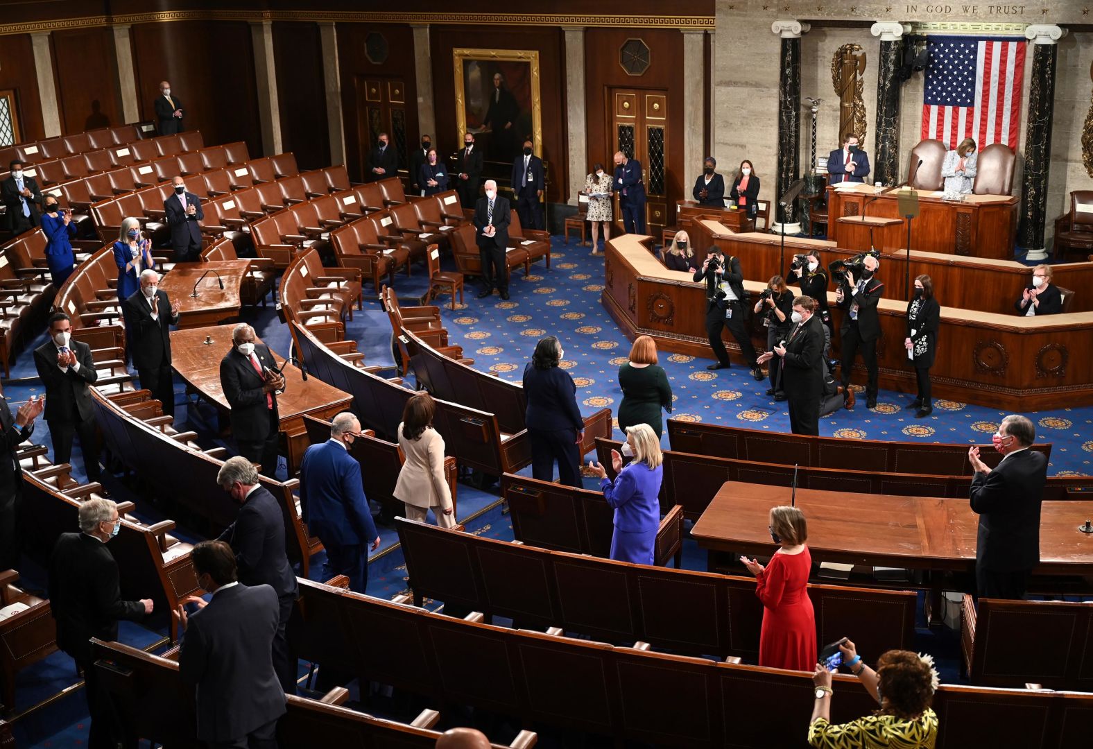 Members of Congress applaud as Harris walks into the House chamber.