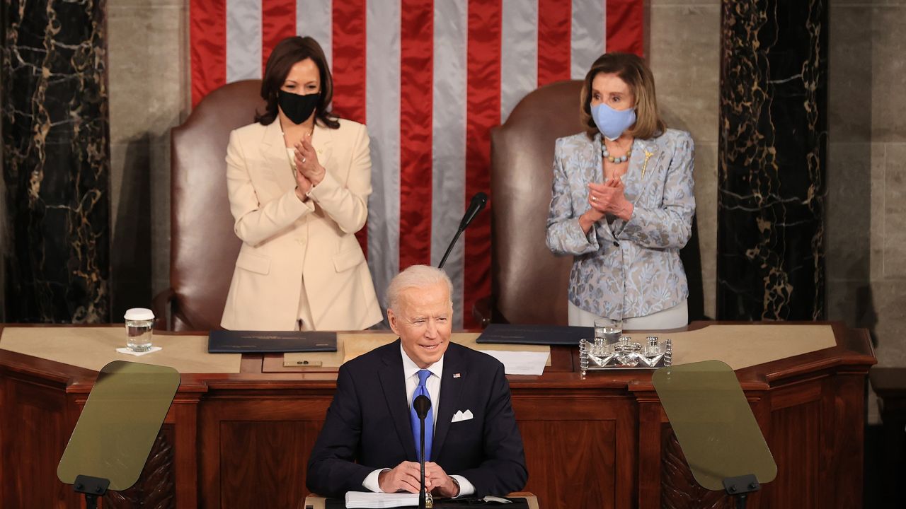 WASHINGTON, DC - APRIL 28: U.S. President Joe Biden addresses a joint session of congress as Vice President Kamala Harris (L) and Speaker of the House U.S. Rep. Nancy Pelosi (D-CA) (R) look on in the House chamber of the U.S. Capitol April 28, 2021 in Washington, DC. On the eve of his 100th day in office, Biden spoke about his plan to revive America's economy and health as it continues to recover from a devastating pandemic. He delivered his speech before 200 invited lawmakers and other government officials instead of the normal 1600 guests because of the ongoing COVID-19 pandemic. (Photo by Chip Somodevilla/Getty Images)