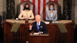 WASHINGTON, DC - APRIL 28: U.S. President Joe Biden addresses a joint session of congress as Vice President Kamala Harris (L) and Speaker of the House U.S. Rep. Nancy Pelosi (D-CA) (R) look on in the House chamber of the U.S. Capitol April 28, 2021 in Washington, DC. On the eve of his 100th day in office, Biden spoke about his plan to revive America's economy and health as it continues to recover from a devastating pandemic. He delivered his speech before 200 invited lawmakers and other government officials instead of the normal 1600 guests because of the ongoing COVID-19 pandemic.