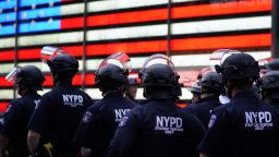 TOPSHOT - NYPD police officers watch demonstrators in Times Square on June 1, 2020, during a "Black Lives Matter" protest. - New York's mayor Bill de Blasio today declared a city curfew from 11:00 pm to 5:00 am, as sometimes violent anti-racism protests roil communities nationwide.
Saying that "we support peaceful protest," De Blasio tweeted he had made the decision in consultation with the state's governor Andrew Cuomo, following the lead of many large US cities that instituted curfews in a bid to clamp down on violence and looting. (Photo by TIMOTHY A. CLARY / AFP) (Photo by TIMOTHY A. CLARY/AFP via Getty Images)