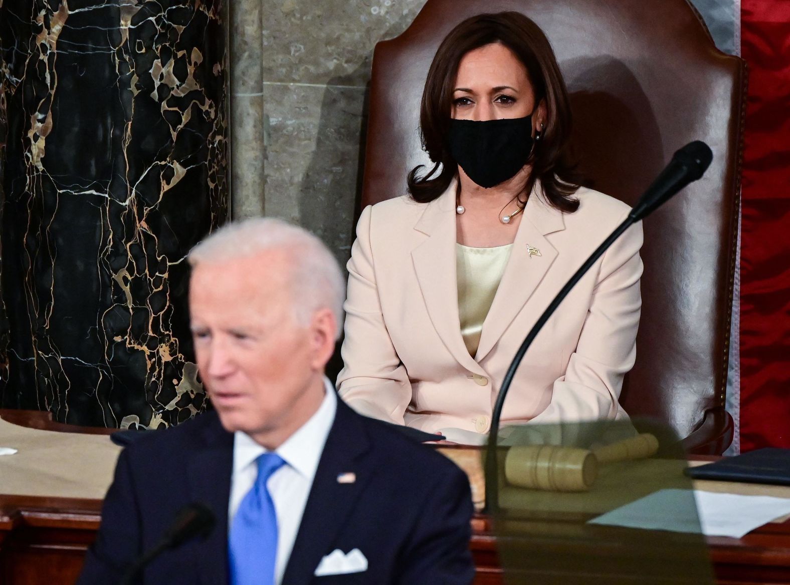 Harris watches Biden speak from the same spot where he once sat. Biden was vice president for eight years.