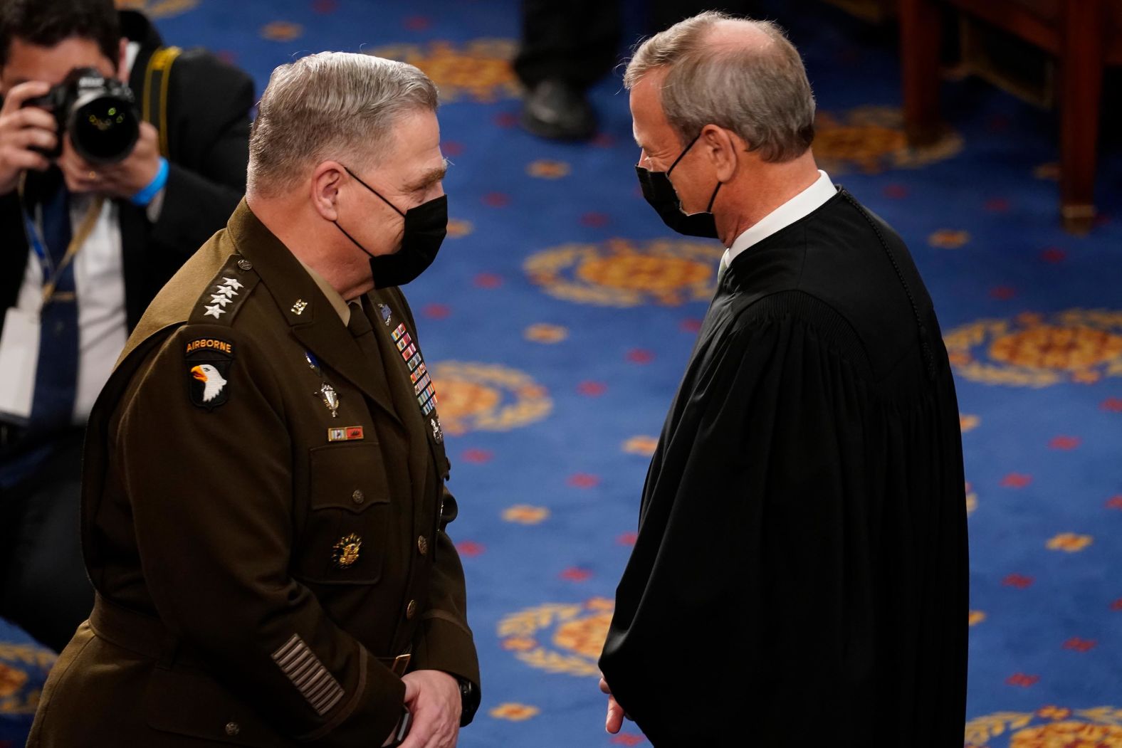 Chief Justice John Roberts talks with Gen. Mark Milley, the chairman of the Joint Chiefs of Staff, before the speech. Because of the pandemic restrictions, Roberts was the only member of the Supreme Court in attendance.
