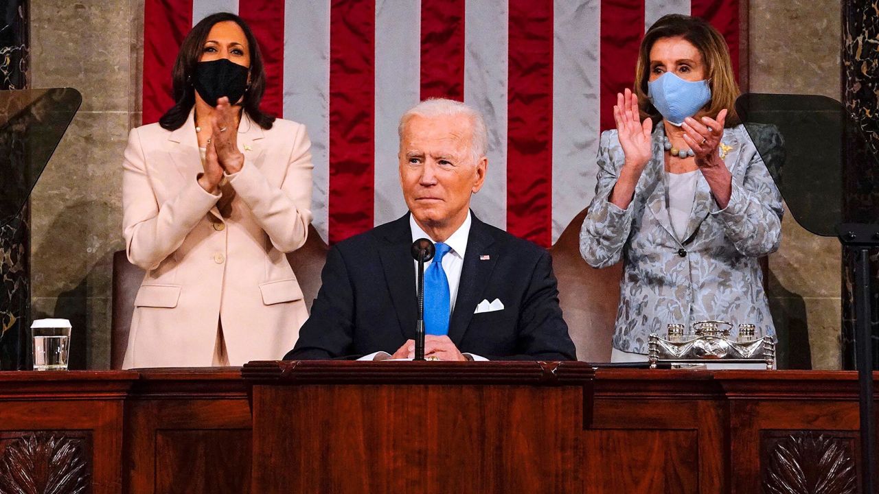 US Vice President Kamala Harris (L) and Speaker of the House of Representatives Nancy Pelos (R) applaud as US President Joe Biden addresses a joint session of Congress at the US Capitol in Washington, DC, on April 28, 2021. 