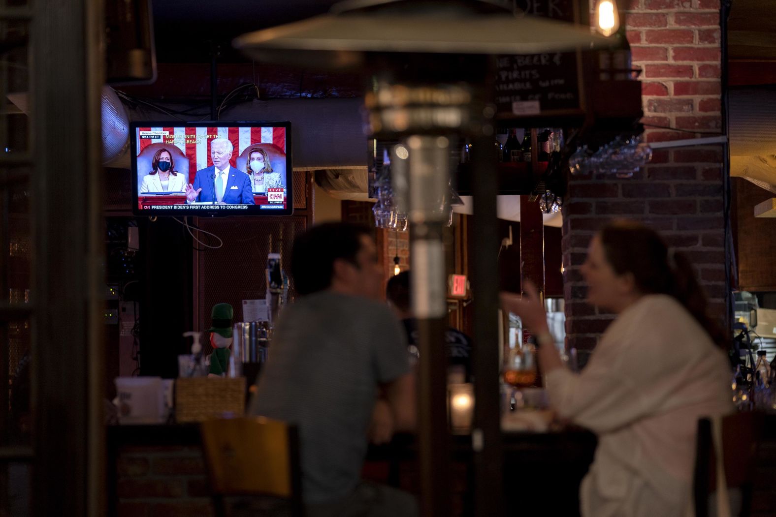 Biden's speech is seen on a television inside a bar in Washington, DC.