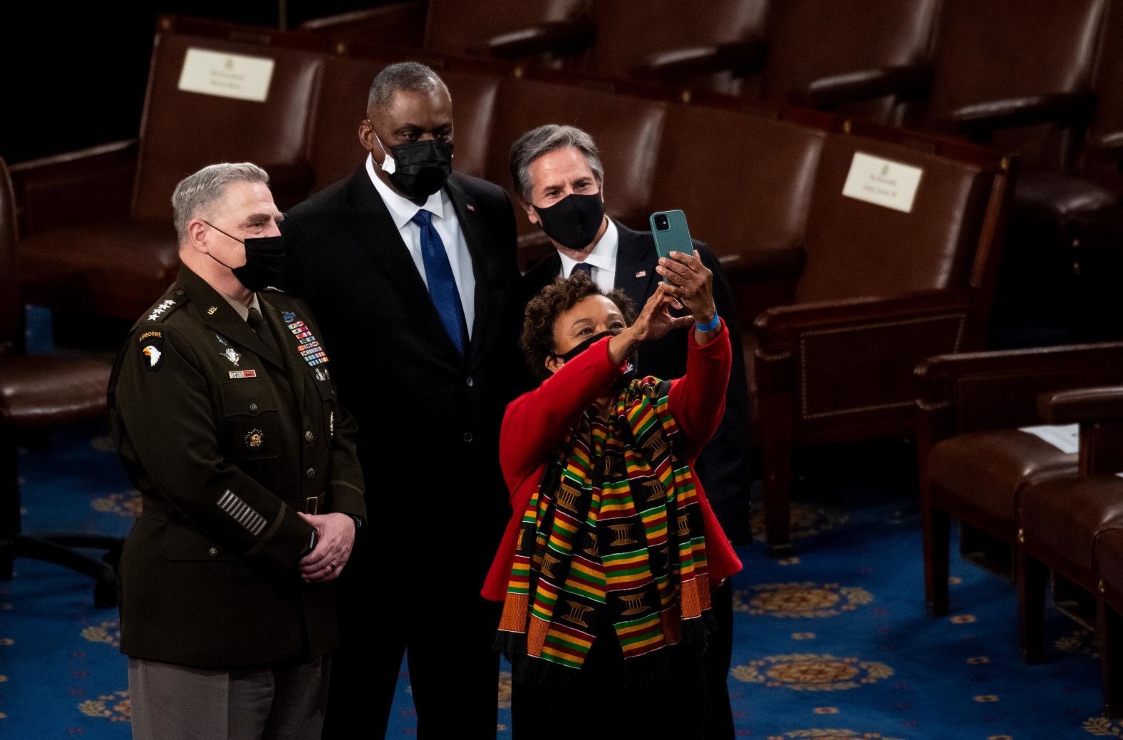 US Rep. Barbara Lee takes a selfie with, from left, Chairman of the Joint Chiefs of Staff Gen. Mark Milley, Secretary of Defense Lloyd Austin and Secretary of State Antony Blinken. Austin and Blinken were the only Cabinet members in attendance.