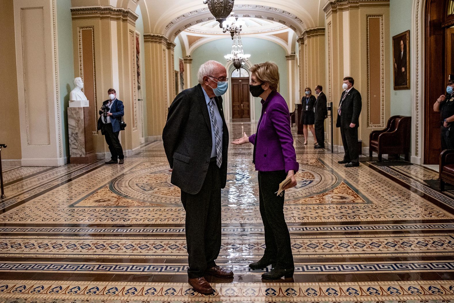 US Sens. Bernie Sanders and Elizabeth Warren chat in the Capitol after Biden's speech. Both competed with Biden last year for the Democratic nomination.