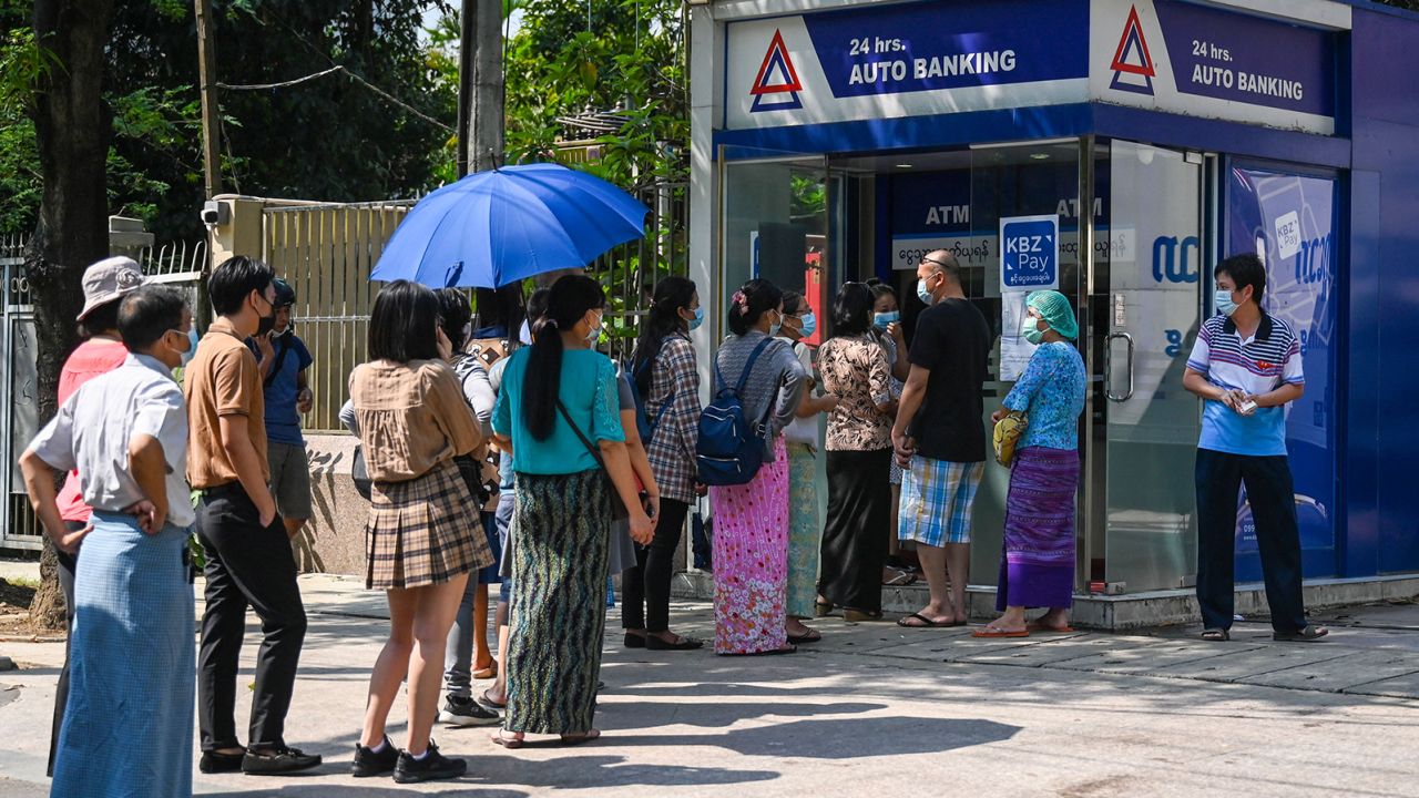 People queue as they wait to use the ATM in Yangon on April 7, 2021, amid strained banking operations due to the military coup. 
