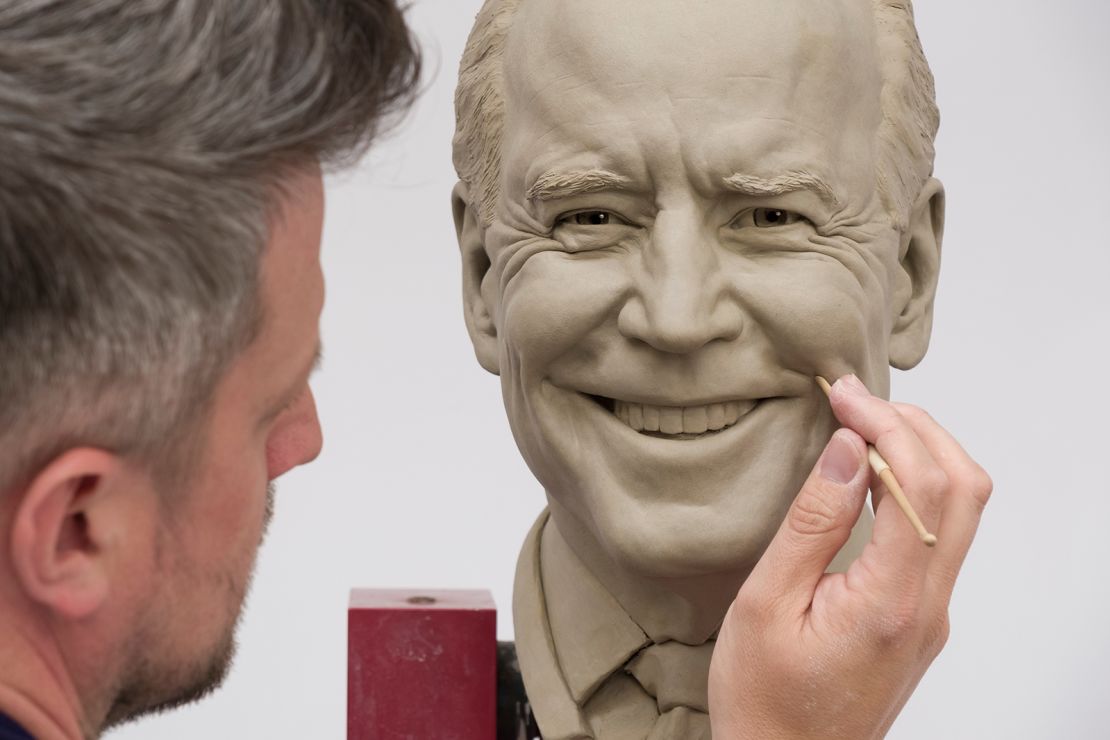 Sculptor David Burks works on the clay bust of President Joe Biden in London.