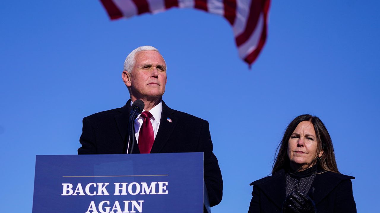 On January 20, 2021, former Vice President Mike Pence speaks after arriving back in his hometown of Columbus, Indiana, as his wife Karen watches.