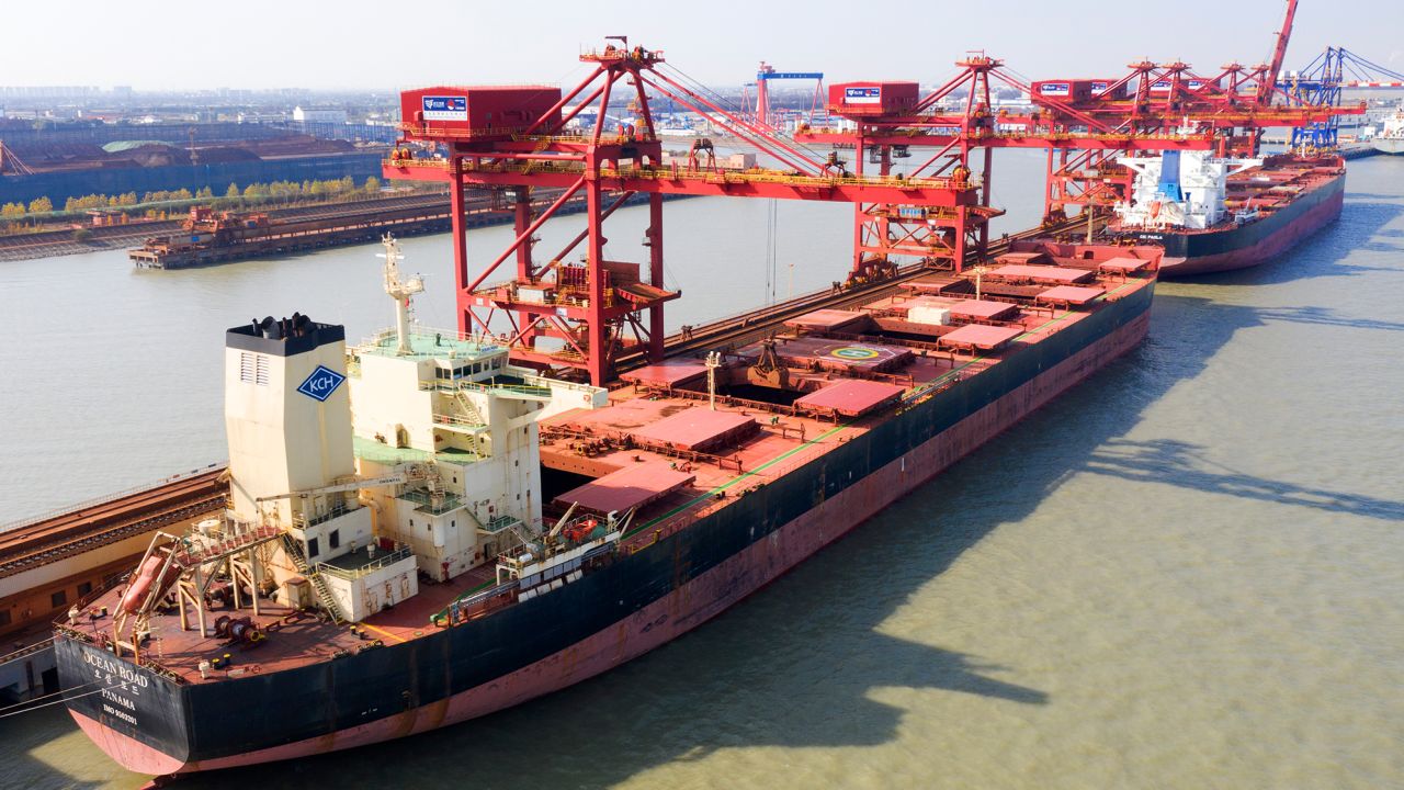 A ship unloading iron ore imported from Australia in Taicang Port in eastern China.