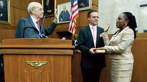 Supreme Court justice Stephen Breyer, left, administers the oath of office to US District Judge Ketanji Brown Jackson, right, with Jackson's husband Patrick Jackson, center, holding the Bible, during an official investiture ceremeony.  May 9, 2013.  