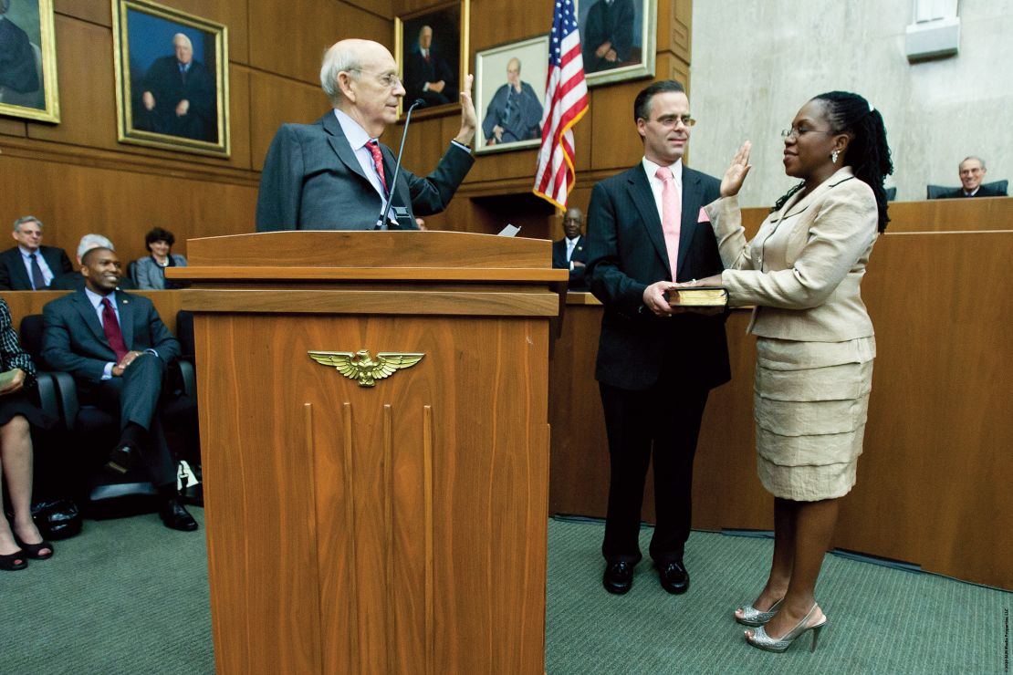 Supreme Court justice Stephen Breyer, left, administers the oath of office to US District Judge Ketanji Brown Jackson, right, with Jackson's husband Patrick Jackson, center, holding the Bible, during an official investiture ceremeony.  May 9, 2013.  