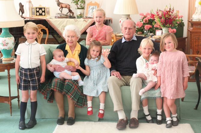 The late Queen Elizabeth II and Prince Philip pose with seven of their great-grandchildren in this photo taken in 2018. The children, from left, are Prince George, Prince Louis, Princess Charlotte, Savannah Phillips, Isla Phillips, Lena Tindall and Mia Tindall.