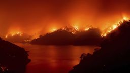 Flames from the LNU Lightning Complex fires burn around Lake Berryessa in unincorporated Napa County, Calif., on Wednesday, Aug. 19, 2020. Fire crews across the region scrambled to contain dozens of wildfires sparked by lightning strikes. (AP Photo/Noah Berger)