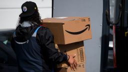 An Amazon.com Inc. delivery driver carries boxes into a van outside of a distribution facility on February 2, 2021 in Hawthorne, California. Jeff Bezos said February 1, 2021, he would give up his role as chief executive of Amazon later this year as the tech and e-commerce giant reported a surge in profit and revenue in the holiday quarter. The announcement came as Amazon reported a blowout holiday quarter with profits more than doubling to $7.2 billion and revenue jumping 44 percent to $125.6 billion. (Photo by Patrick T. Fallon/AFP/Getty Images)