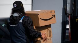 An Amazon.com Inc. delivery driver carries boxes into a van outside of a distribution facility on February 2, 2021 in Hawthorne, California. Jeff Bezos said February 1, 2021, he would give up his role as chief executive of Amazon later this year as the tech and e-commerce giant reported a surge in profit and revenue in the holiday quarter. The announcement came as Amazon reported a blowout holiday quarter with profits more than doubling to $7.2 billion and revenue jumping 44 percent to $125.6 billion. (Photo by Patrick T. Fallon/AFP/Getty Images)