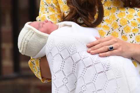 Catherine holds newborn Princess Charlotte while speaking to the media outside a London hospital in 2015.