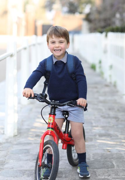 Prince Louis, William and Kate's youngest son, rides his bicycle before leaving for his first day of nursery school in April 2021. Louis is fifth in line to the throne.