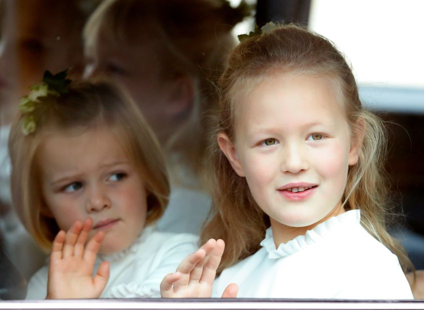 Cousins Mia Tindall, left, and Savannah Phillips attend the wedding of Princess Eugenie in 2018. Mia and Savannah are two grandchildren of the Queen's only daughter, Princess Anne. Mia is one of three children born to Mike and Zara Tindall. Savannah is one of two children born to Peter and Autumn Phillips.