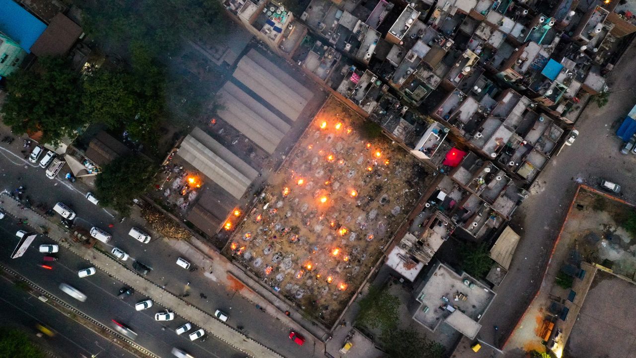 In this aerial picture taken on April 26, burning pyres of victims who lost their lives due to Covid-19 are seen at a cremation ground in New Delhi.