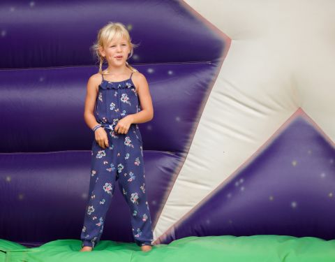 Isla Phillips, Savannah's sister, plays on an inflatable slide during a festival in 2018.