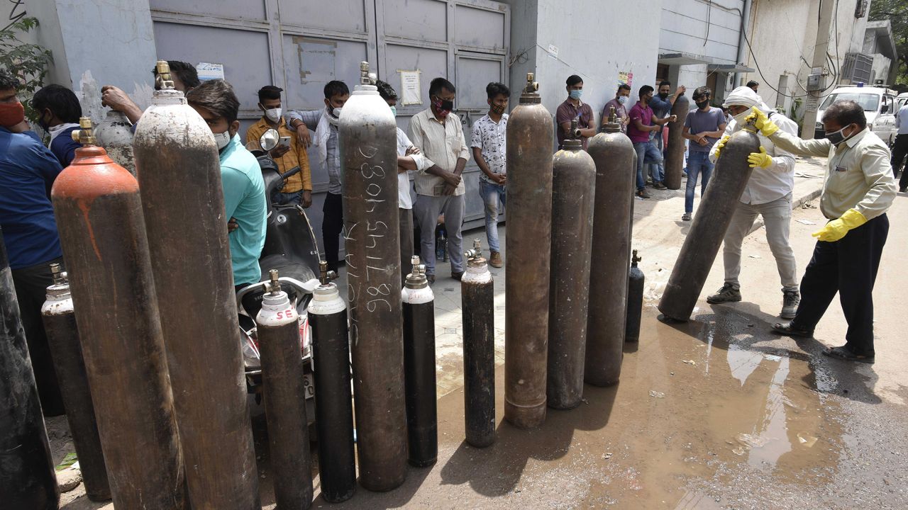 Family members of Covid-19 patients waiting to refill empty oxygen cylinders in Manesar, India.