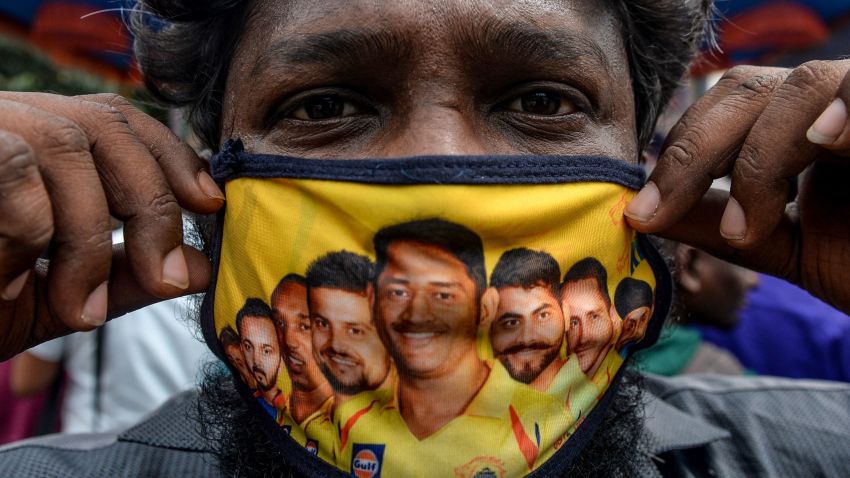 A man shows his facemask decorated with portraits of Chennai Super Kings cricket captain Mahendra Singh Dhoni (C) and other team players as Covid-19 coronavirus cases continue to rise in the country, in Chennai on September 16, 2020. (Photo by Arun SANKAR / AFP) (Photo by ARUN SANKAR/AFP via Getty Images)