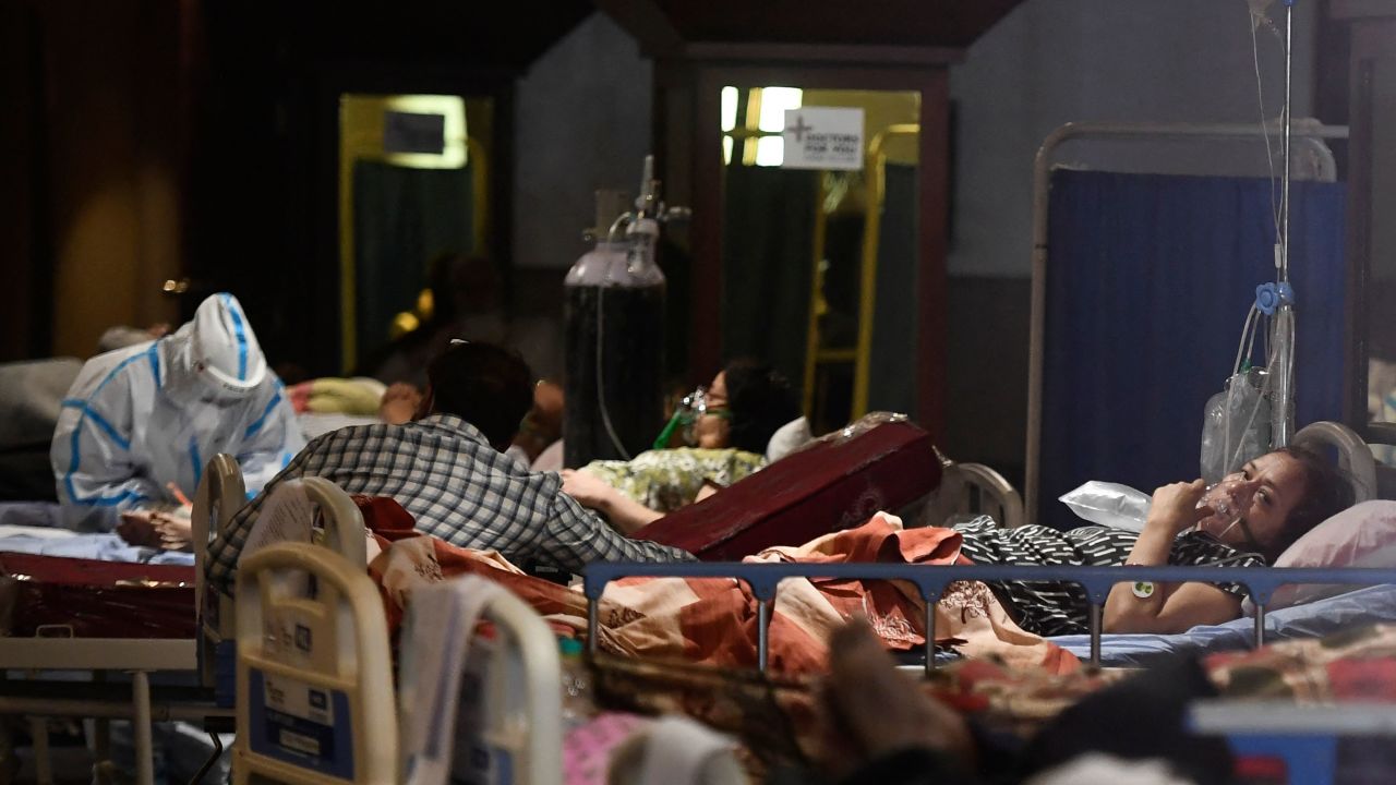 Covid-19 coronavirus patients rest inside a banquet hall temporarily converted into a Covid-19 coronavirus ward in New Delhi on April 29, 2021.