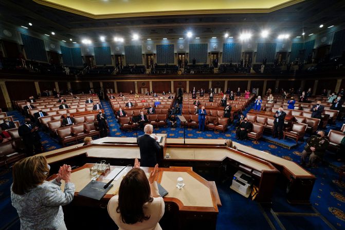 Biden addresses a joint session of Congress in April 2021. Because of Covid-19 restrictions, only a limited number of lawmakers were in the House chamber. <a href="https://www.cnn.com/2021/04/28/politics/gallery/biden-first-address-joint-session-congress/index.html" target="_blank">Biden's speech</a> focused on the administration's accomplishments thus far and unveiled key components of his next legislative push.