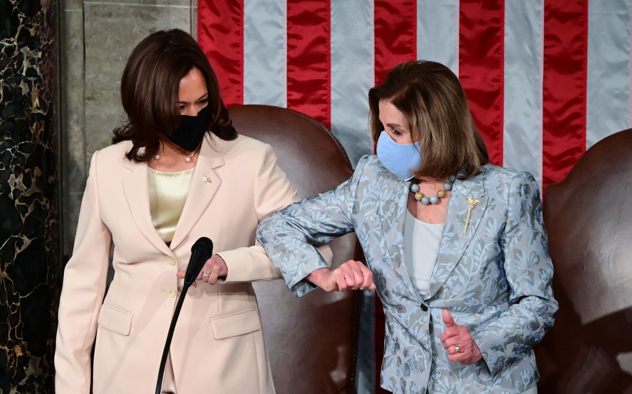 Vice President Kamala Harris, left, greets House Speaker Nancy Pelosi with an elbow bump before <a href="https://www.cnn.com/2021/04/28/politics/gallery/biden-first-address-joint-session-congress/index.html" target="_blank">President Joe Biden's address to Congress</a> on Wednesday, April 28. It's the first time in history that two women were seated behind the President for a joint address.