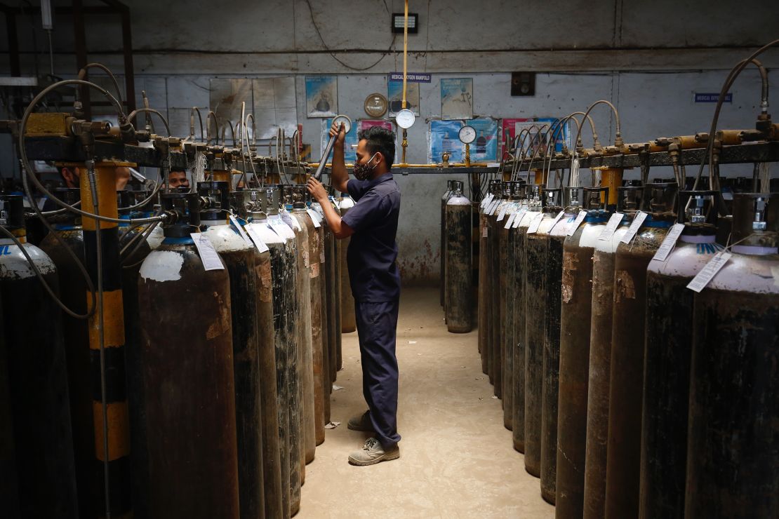 An employee fills oxygen cylinders inside an oxygen filling centre on April 28, 2021 in Bengaluru, India.