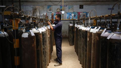 An employee fills oxygen cylinders in Bengaluru, India. 