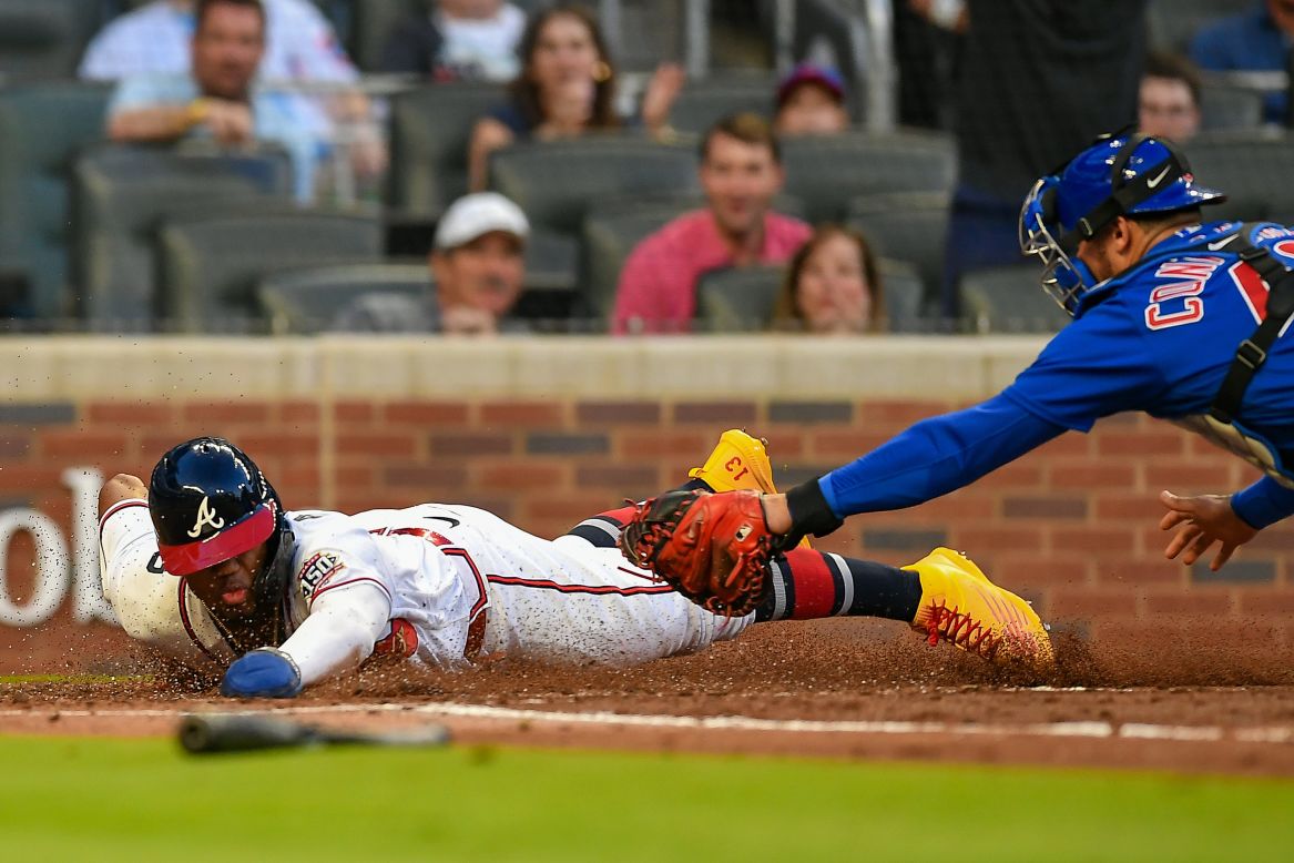 Atlanta's Ronald Acuña Jr. slides safely into home during a game against the Chicago Cubs on Wednesday, April 28. The Braves rolled to a 10-0 victory.